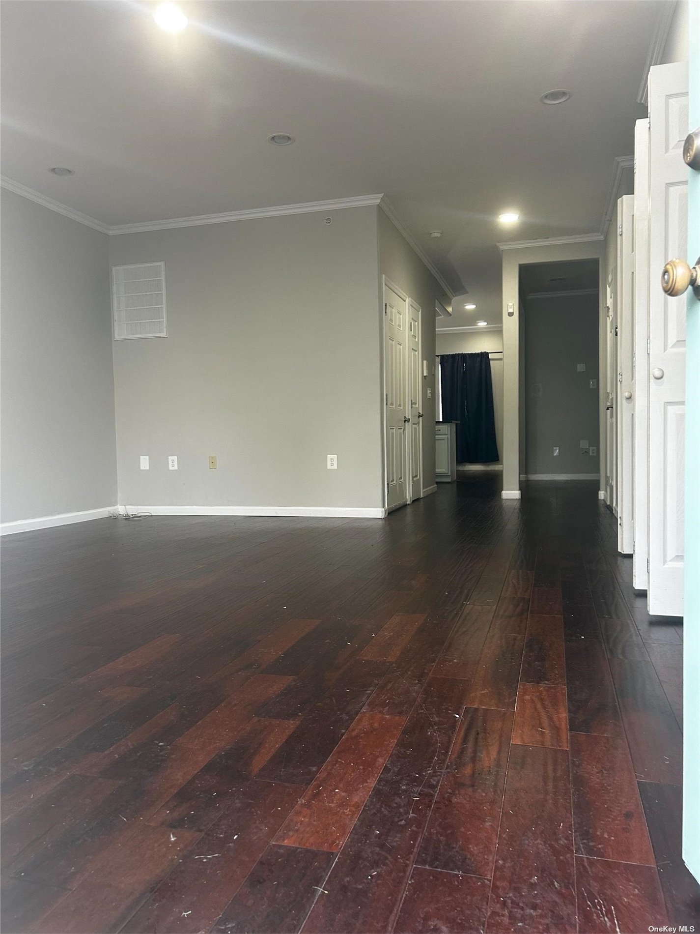 a view of a hallway with wooden floor