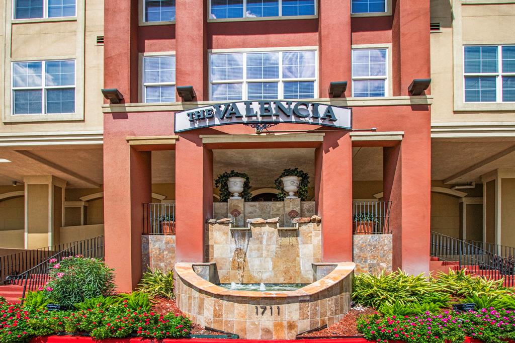 front view of a building with a fountain