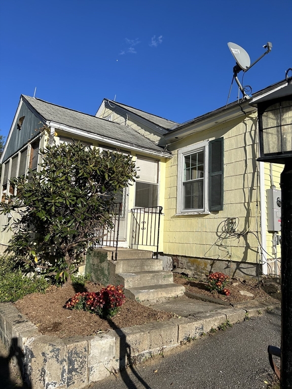 a front view of a house with outdoor seating