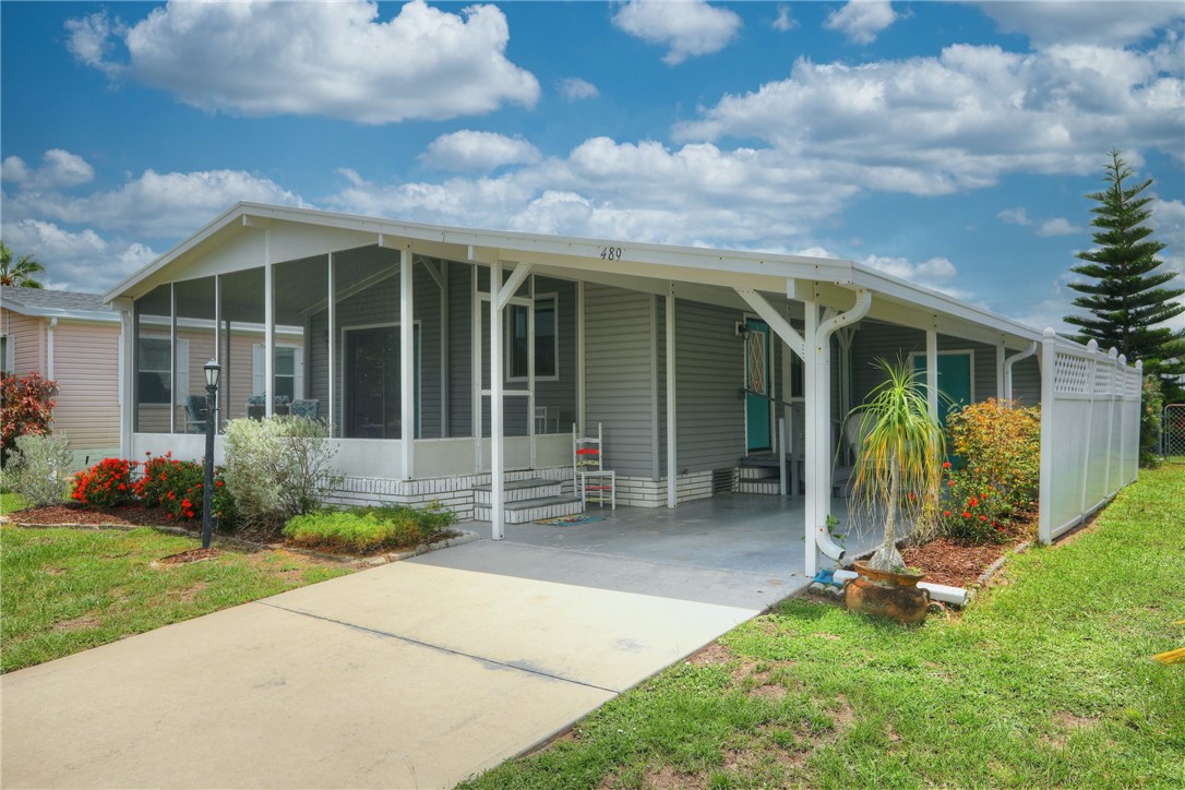 a view of a house with porch and garden