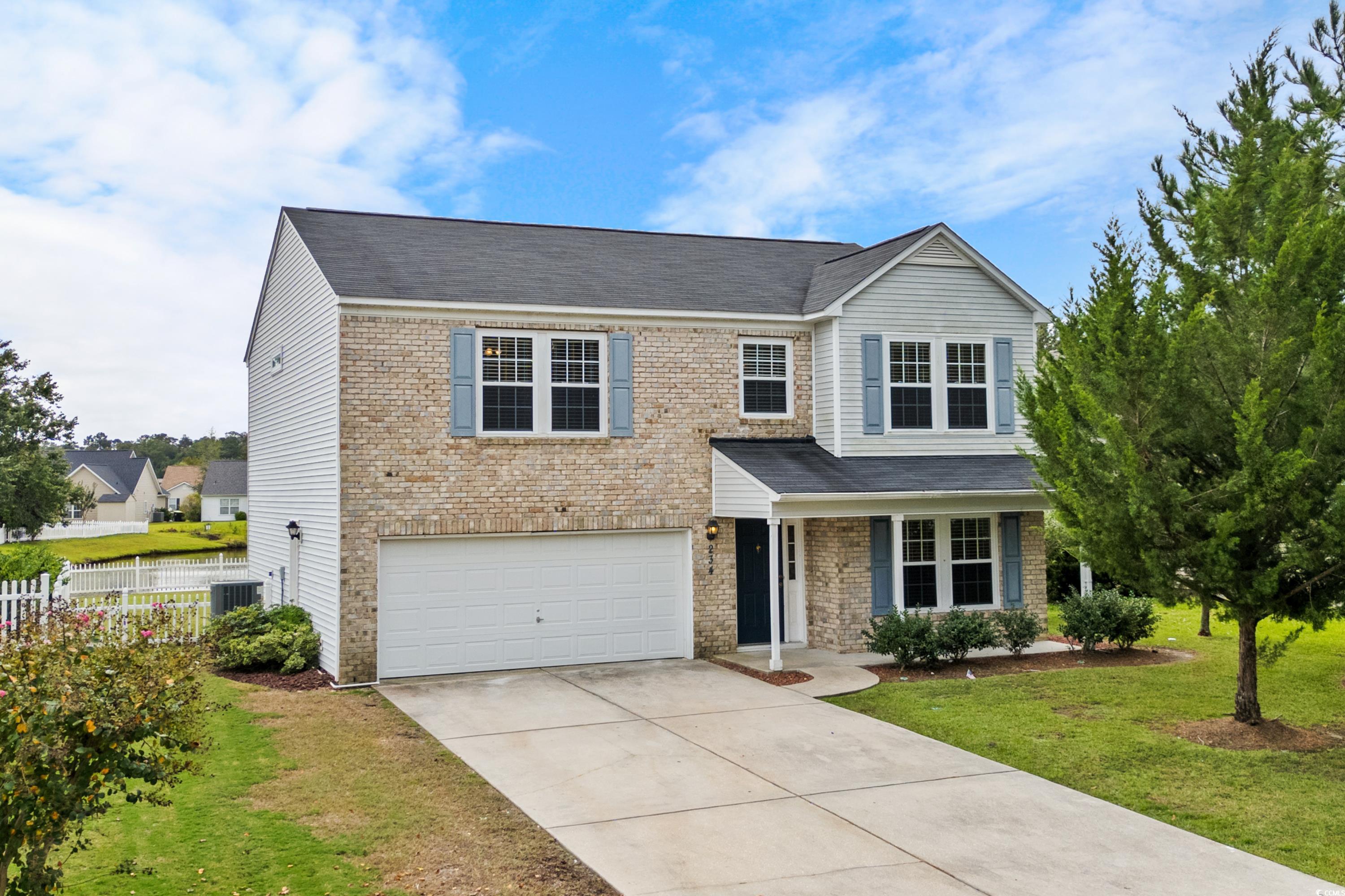 View of front facade with a garage, a front yard,