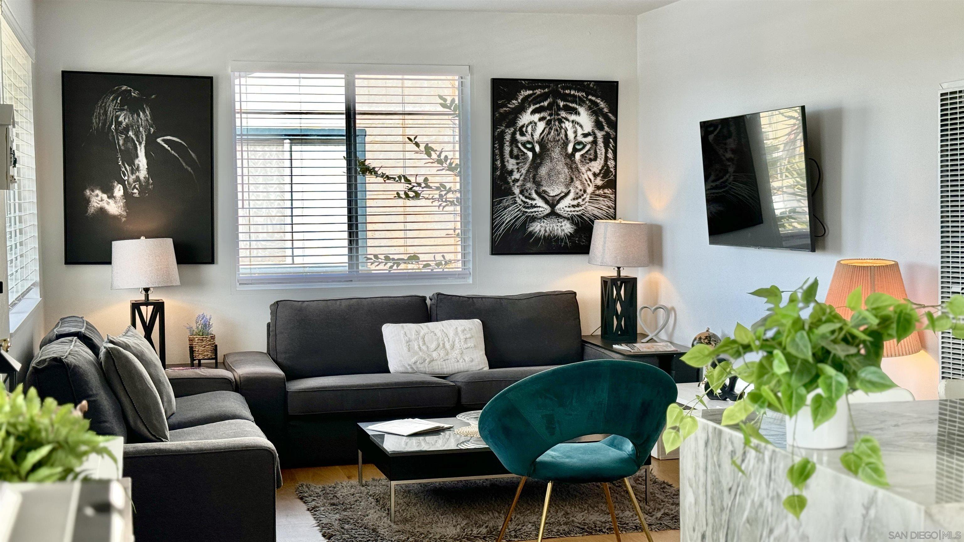 a living room with furniture and a potted plant