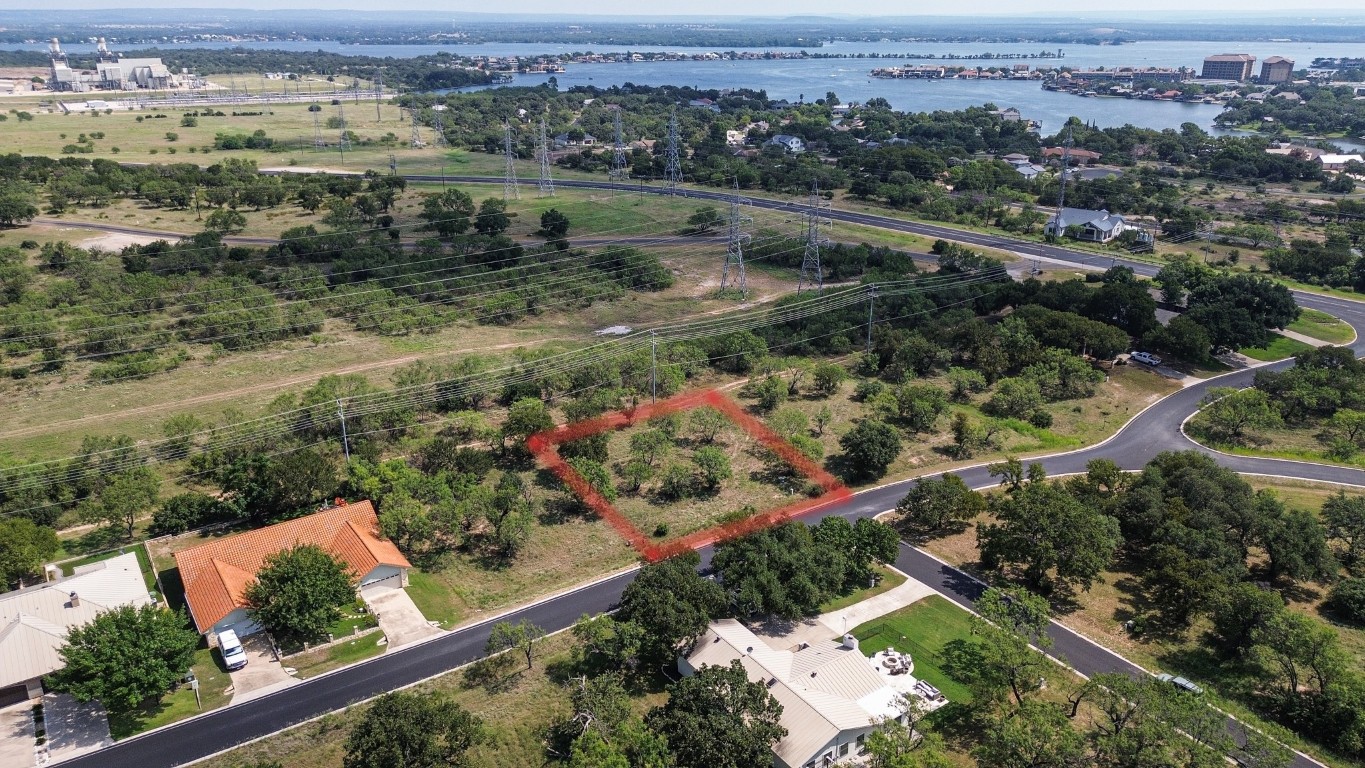 an aerial view of lake and residential houses with outdoor space