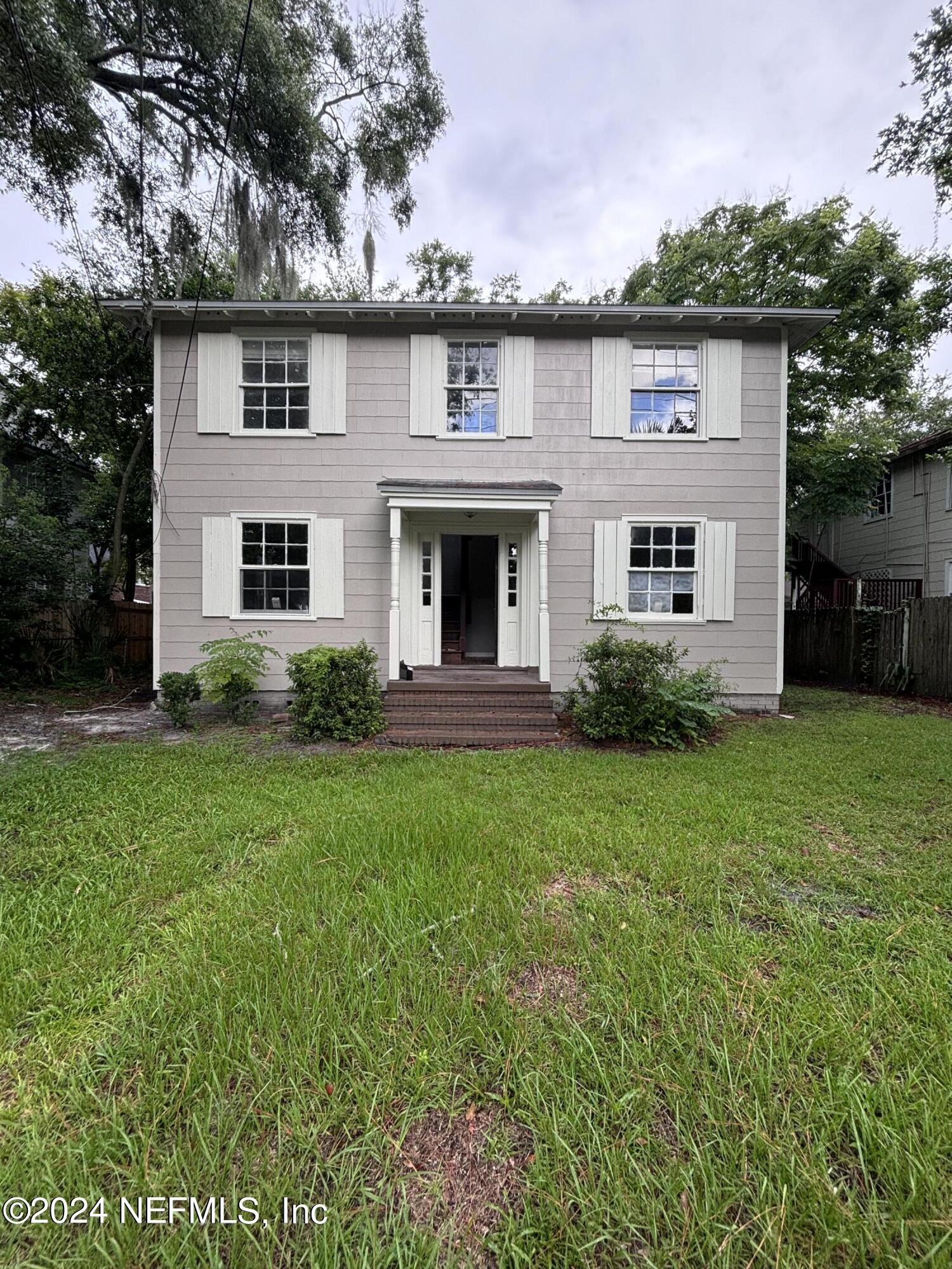 a front view of house with yard and green space