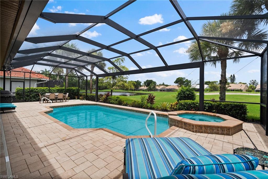 View of pool featuring a lanai, an in ground hot tub, and a patio