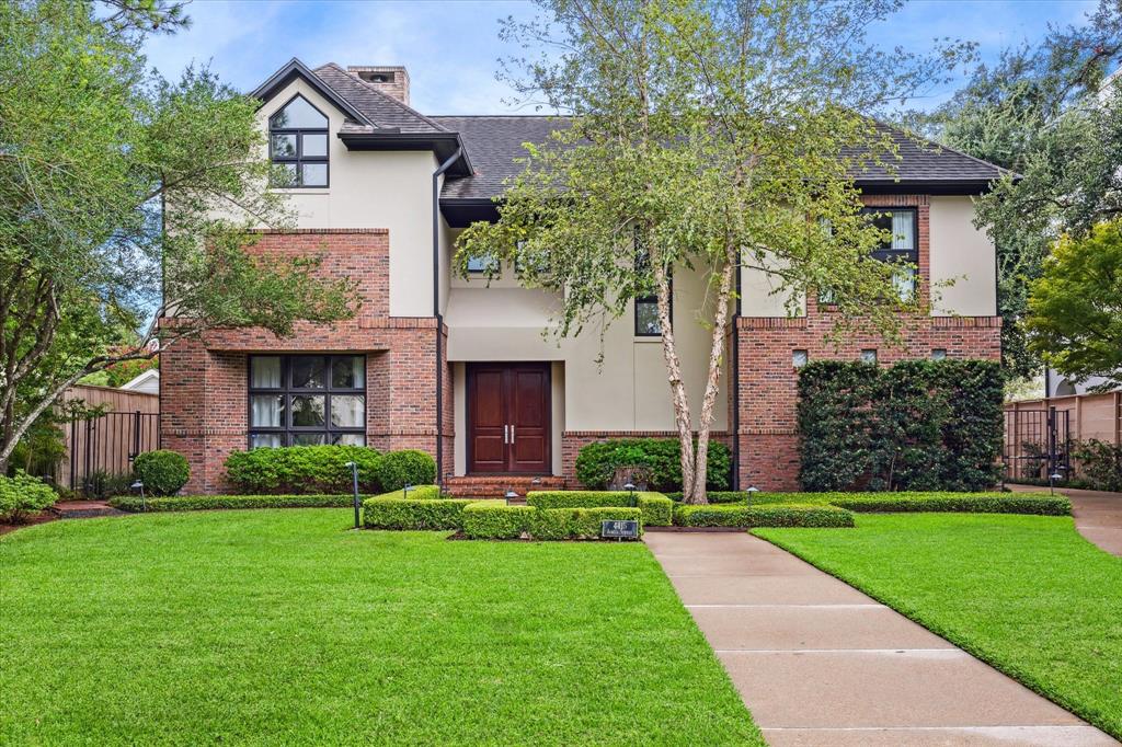 a front view of a house with a garden and plants