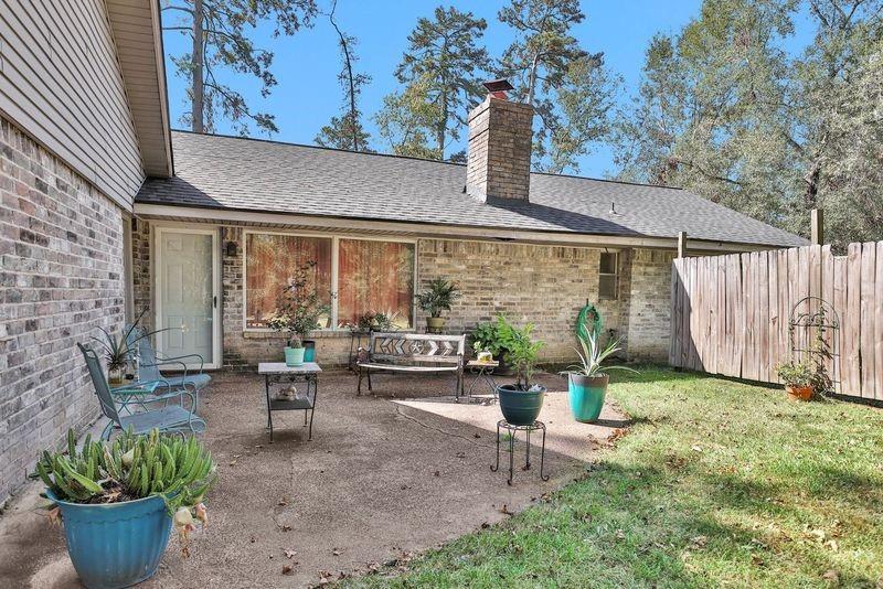 a front view of a house with garden and sitting area