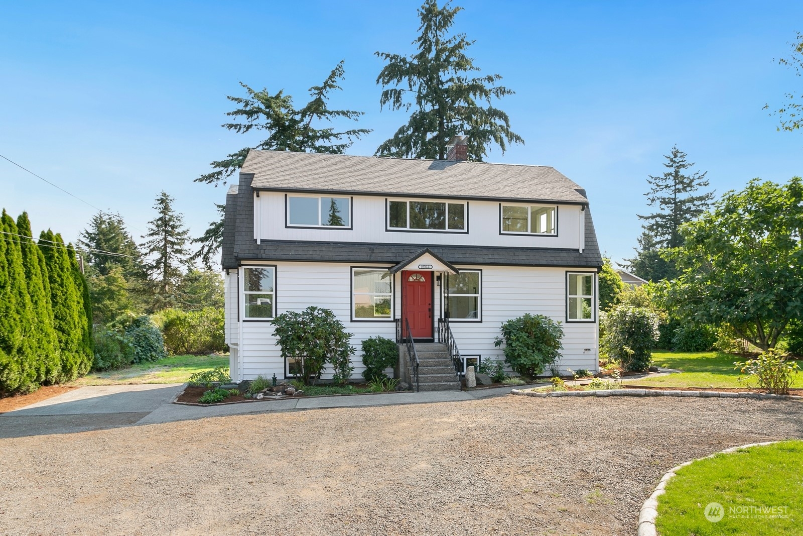 a front view of a house with a yard and a garage