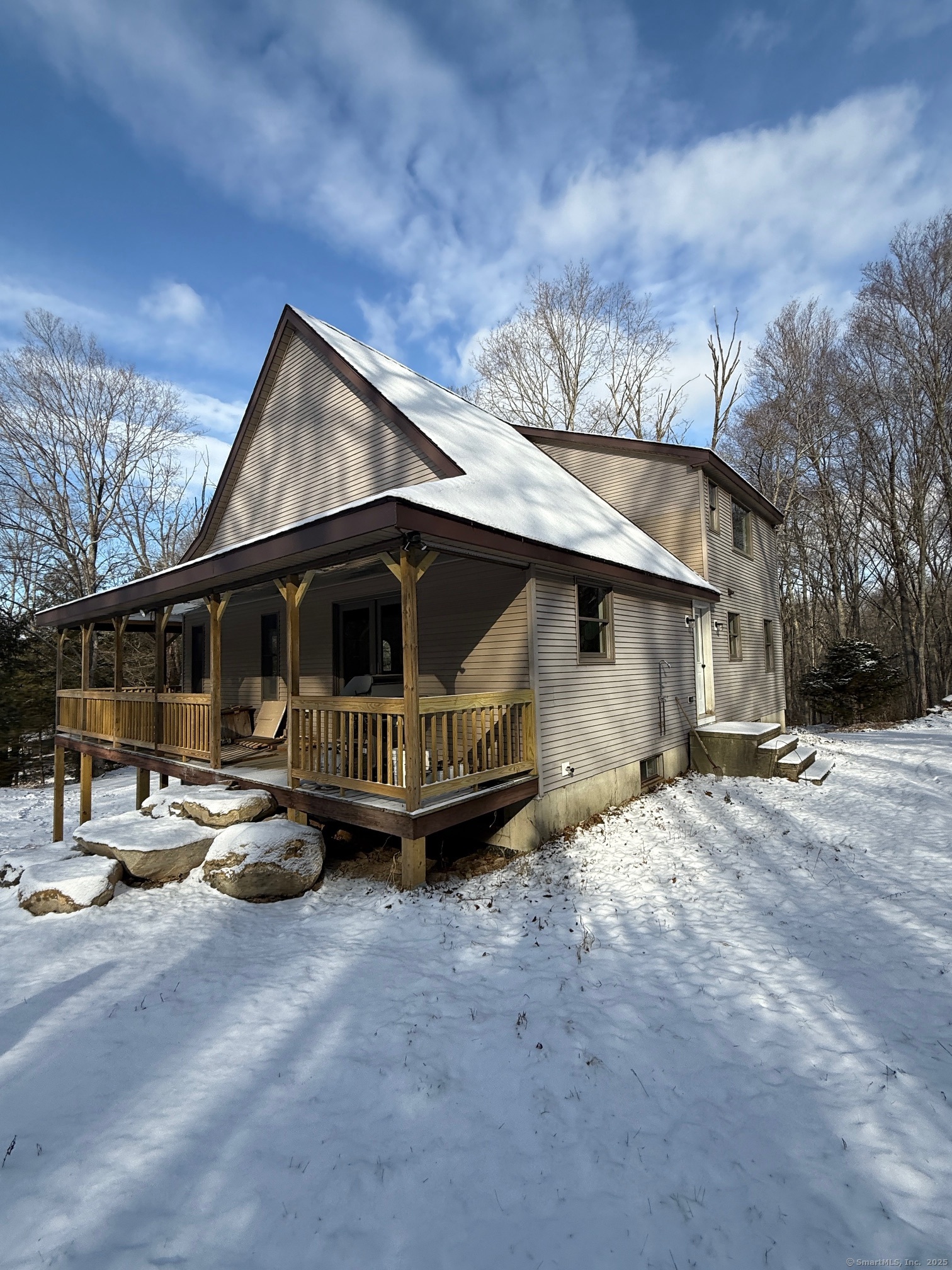 a view of a house with a yard and sitting area