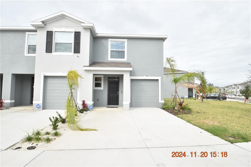 a front view of a house with a yard