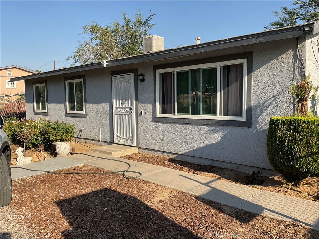 a front view of a house with a yard and seating space