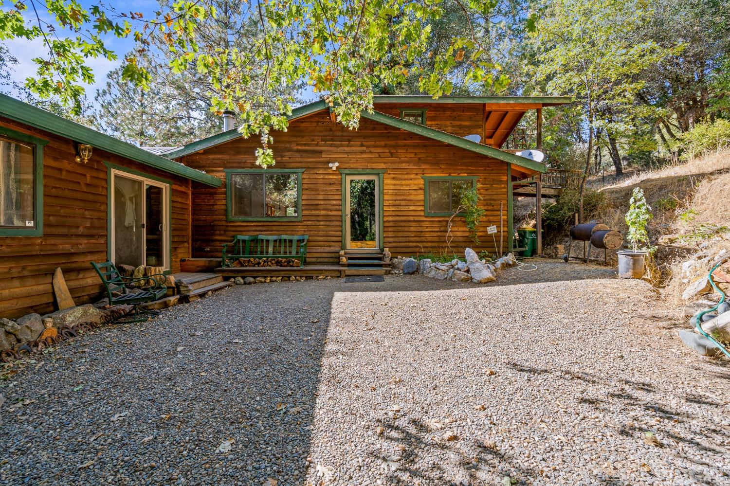 a view of a house with a yard and wooden fence