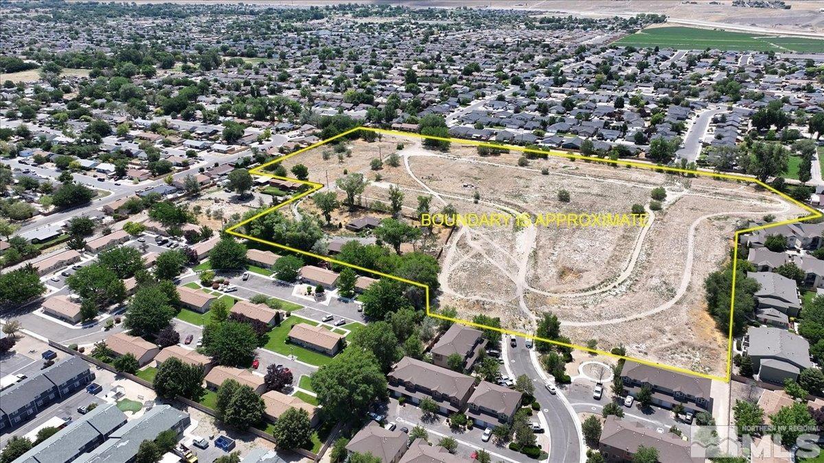 an aerial view of residential houses with yard