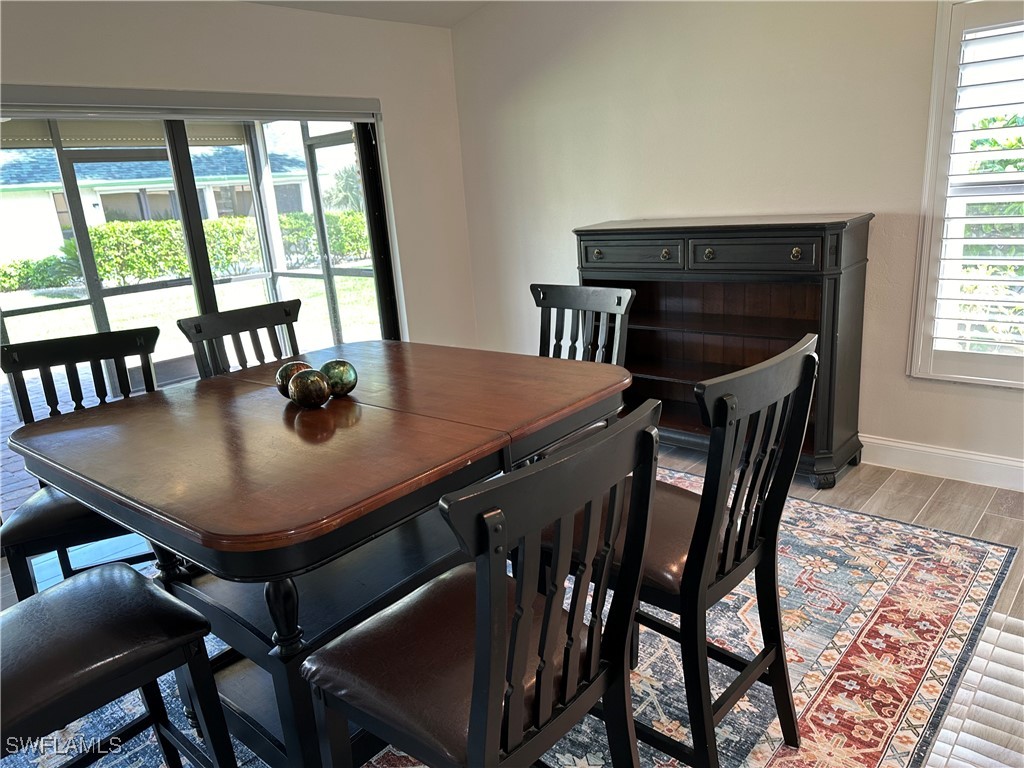 a view of a dining room with furniture and window