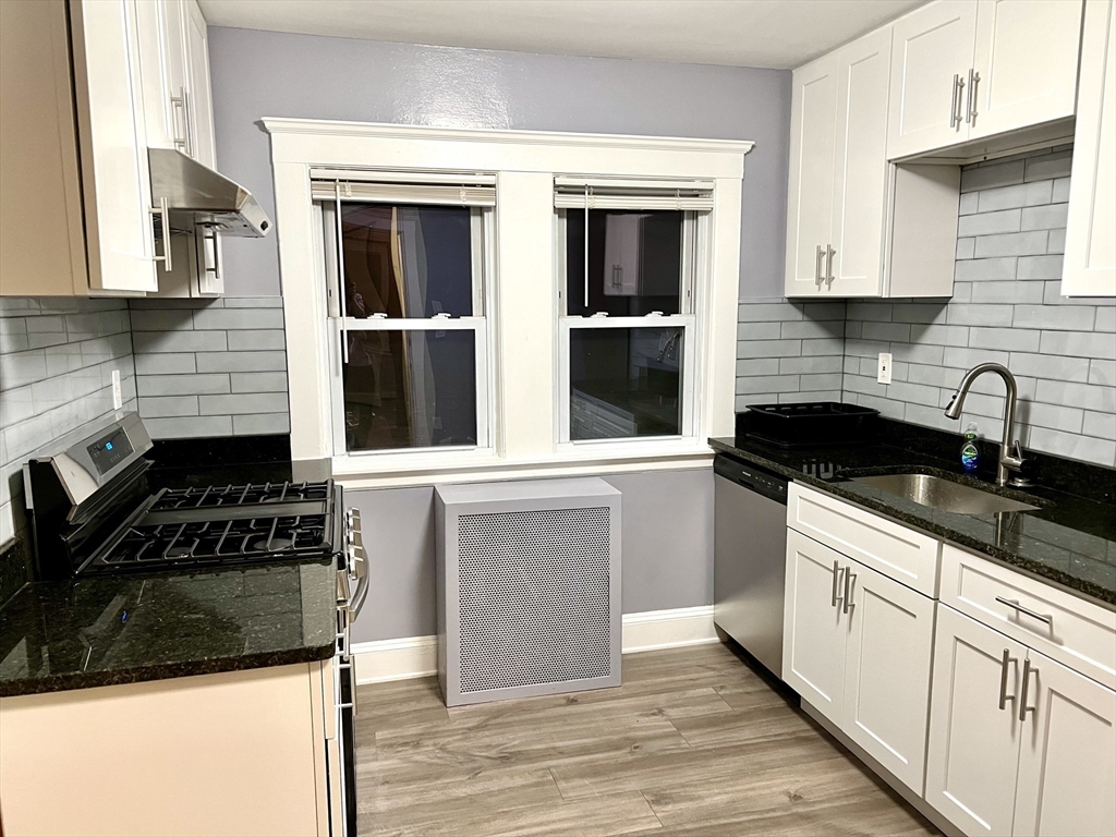 a kitchen with cabinets and appliances