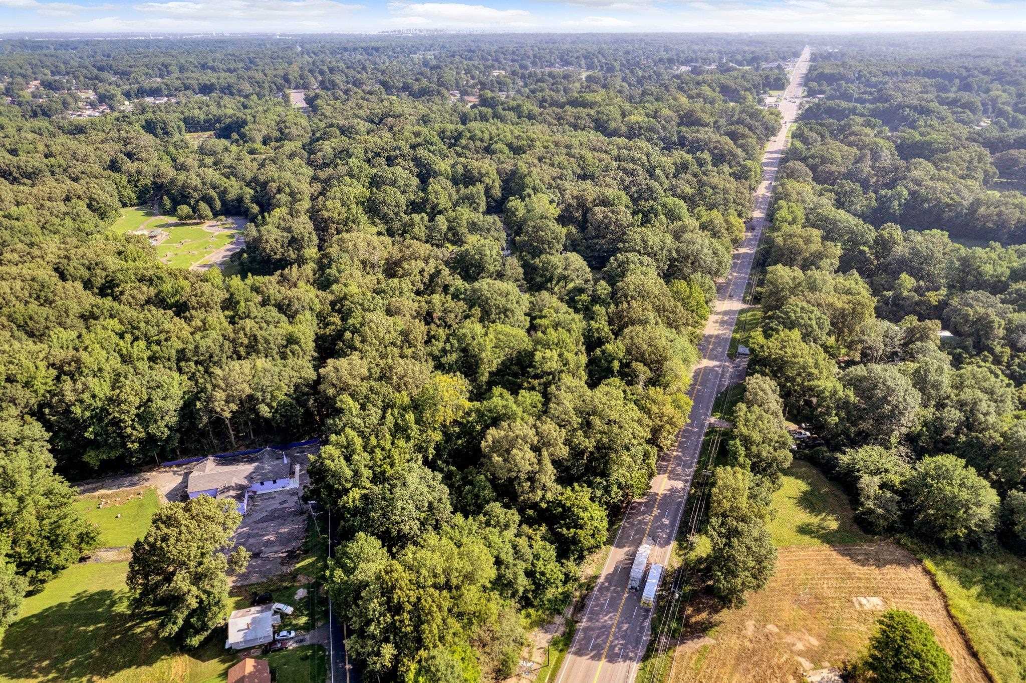 an aerial view of a houses with a yard