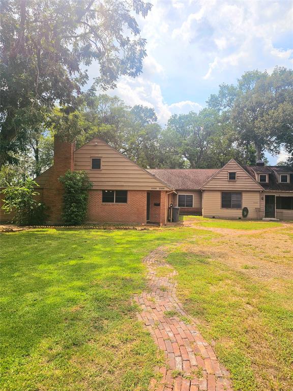 a front view of house with yard and swimming pool