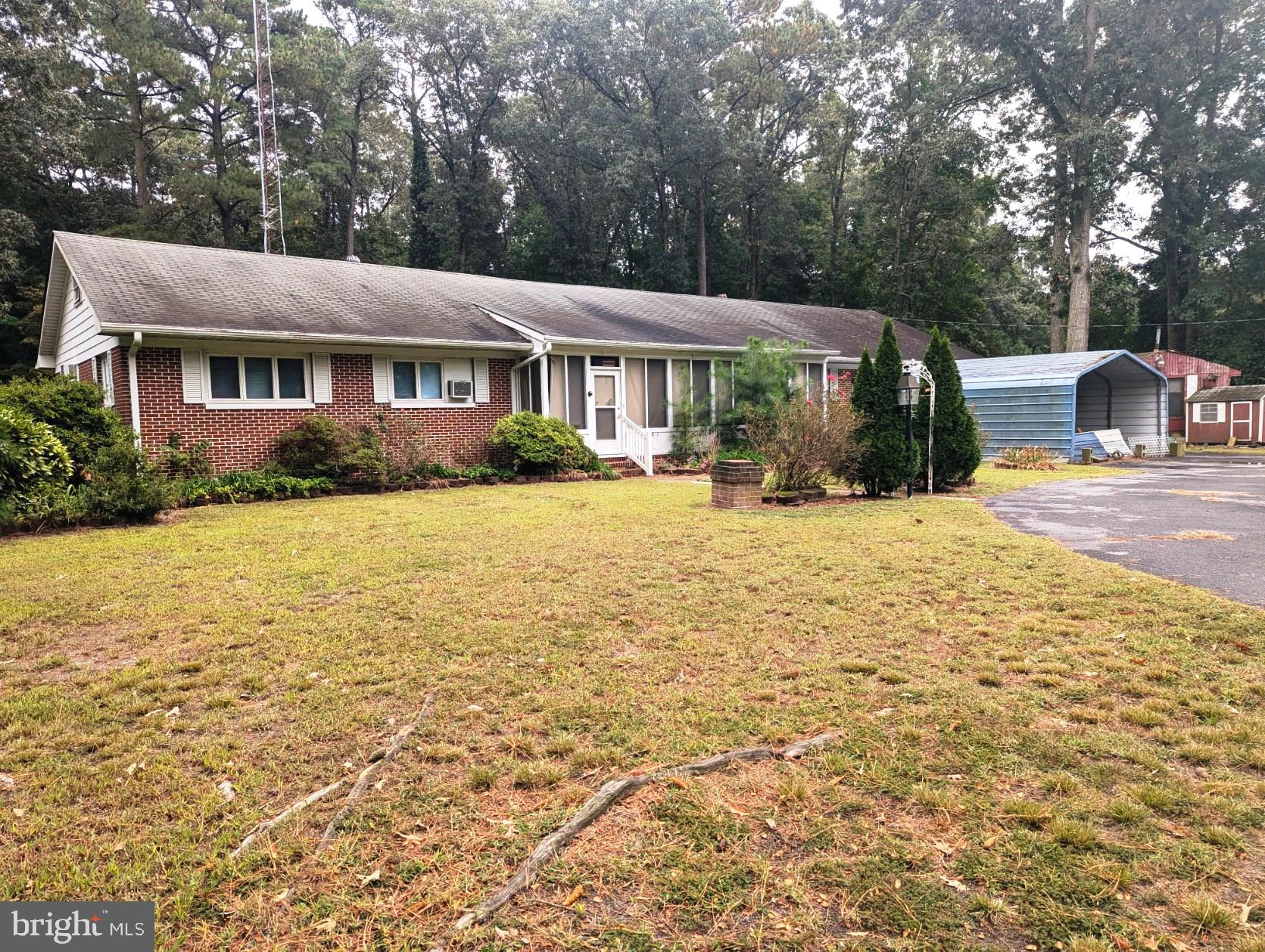 a view of a house with yard and sitting area