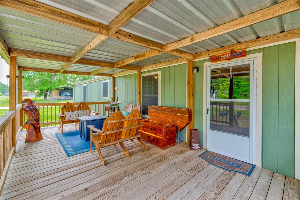 a outdoor space with the couches and dining table with wooden floors