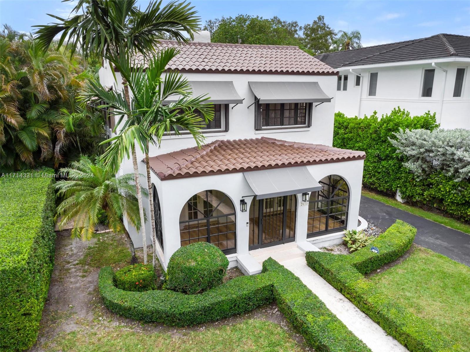 a front view of a house with a yard