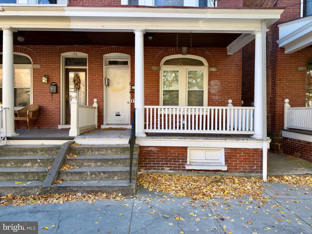 a view of front door of house with stairs