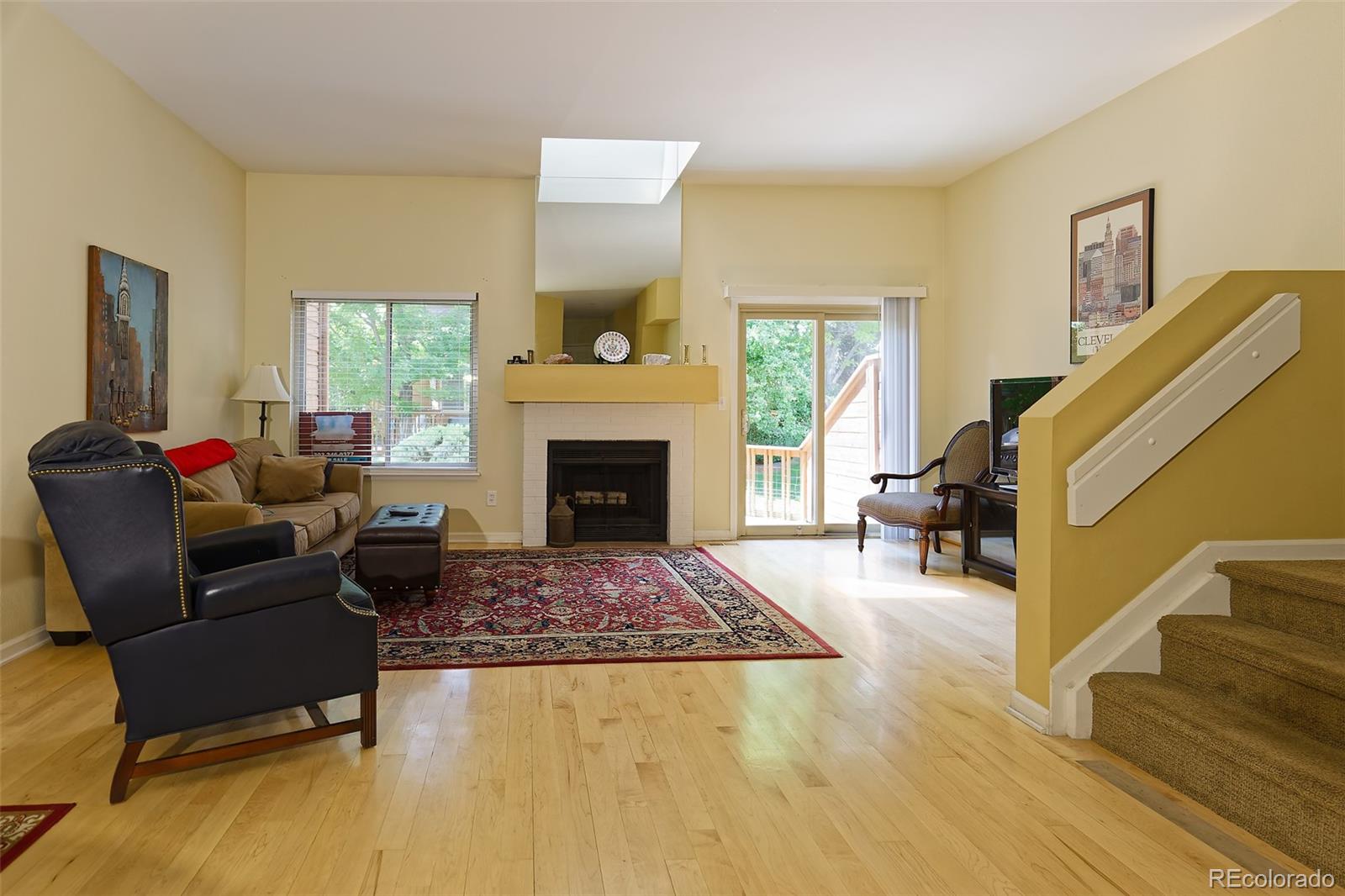 a living room with furniture rug and a fireplace