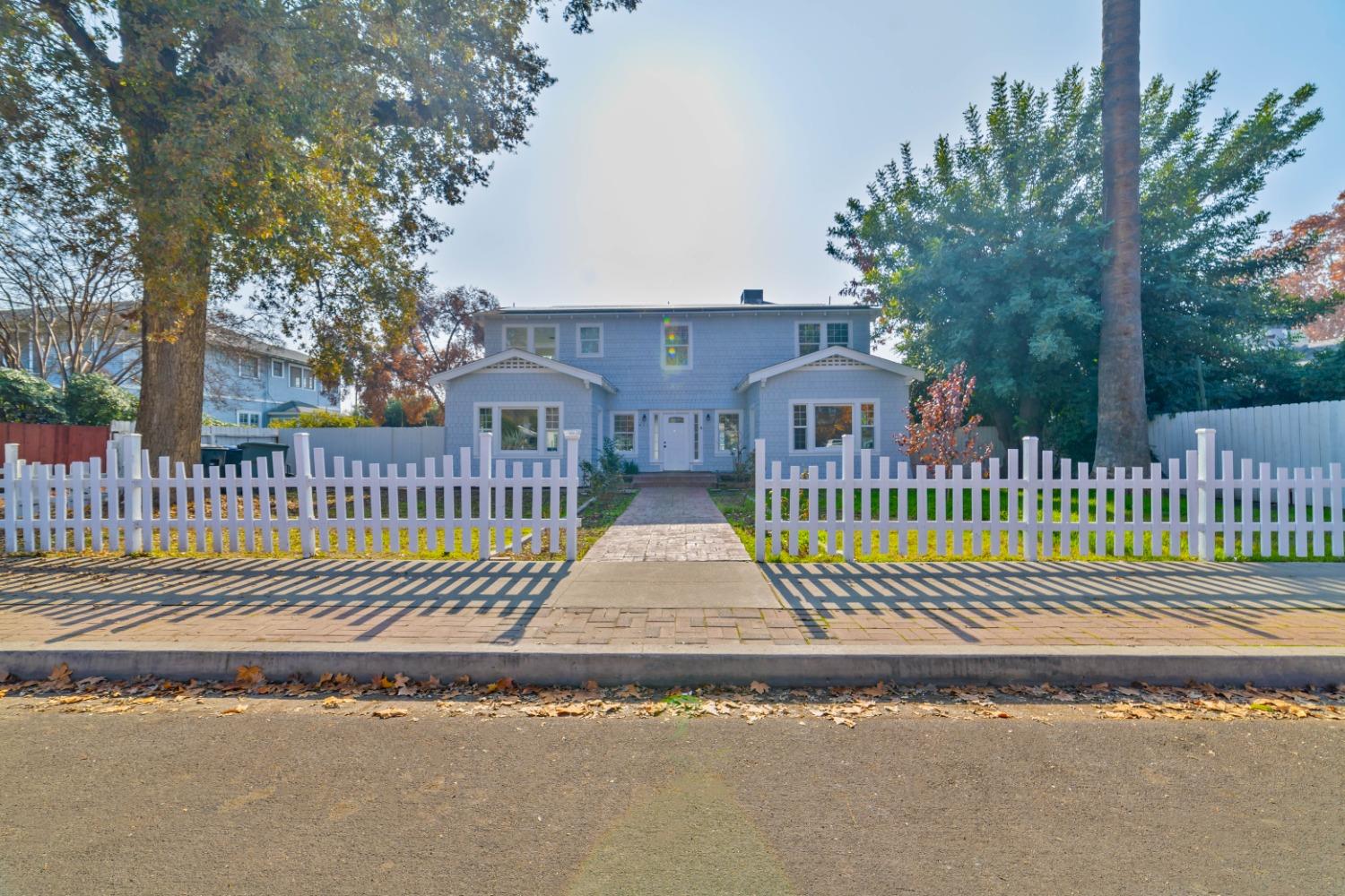 a front view of a house with a garden and deck