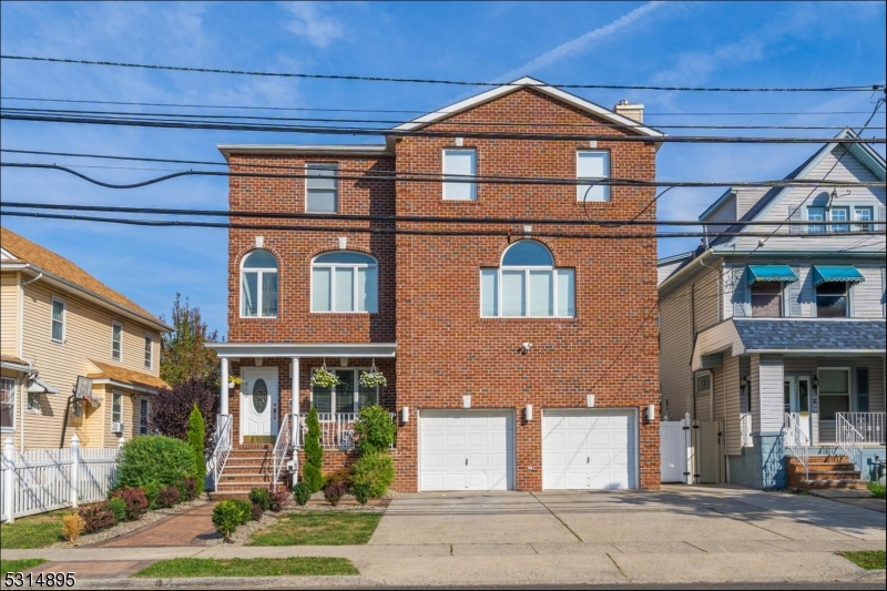 a front view of a residential apartment building with a yard