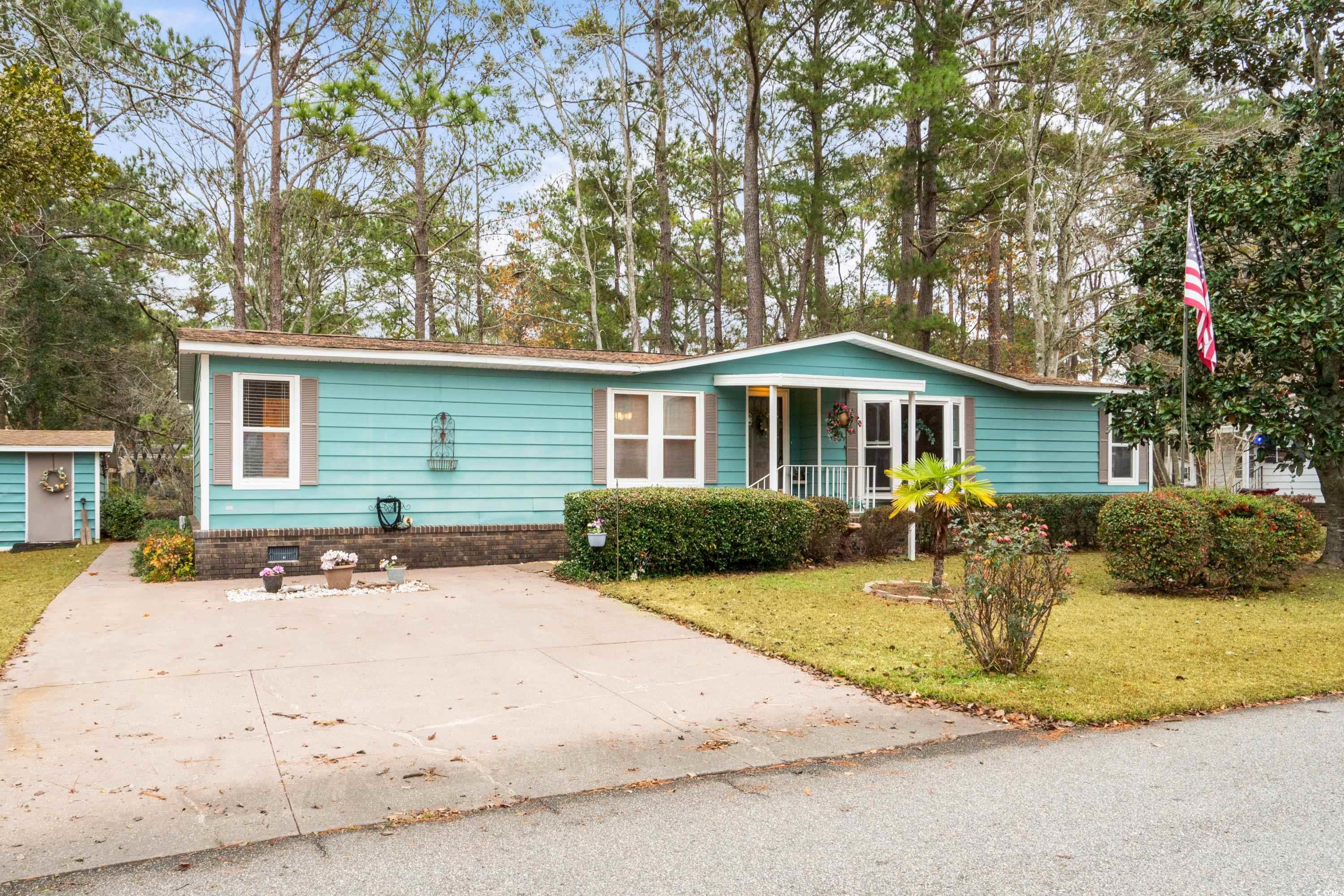 Single story home with a storage unit, a porch, an