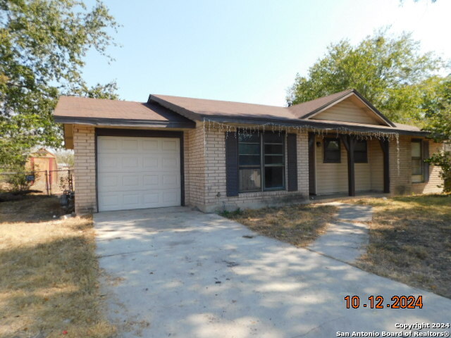 a view of a house with a yard and garage