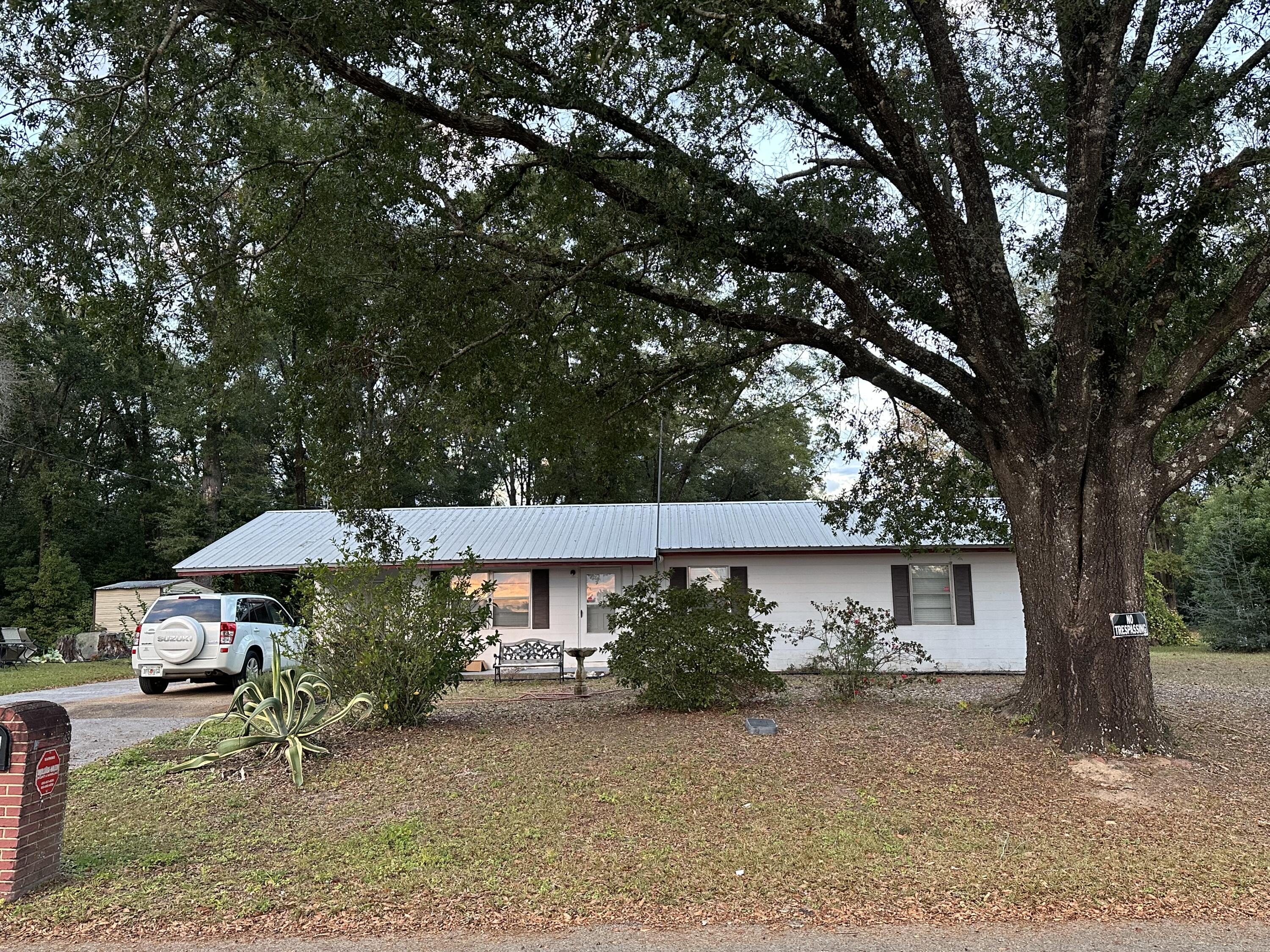 front view of a house with a tree