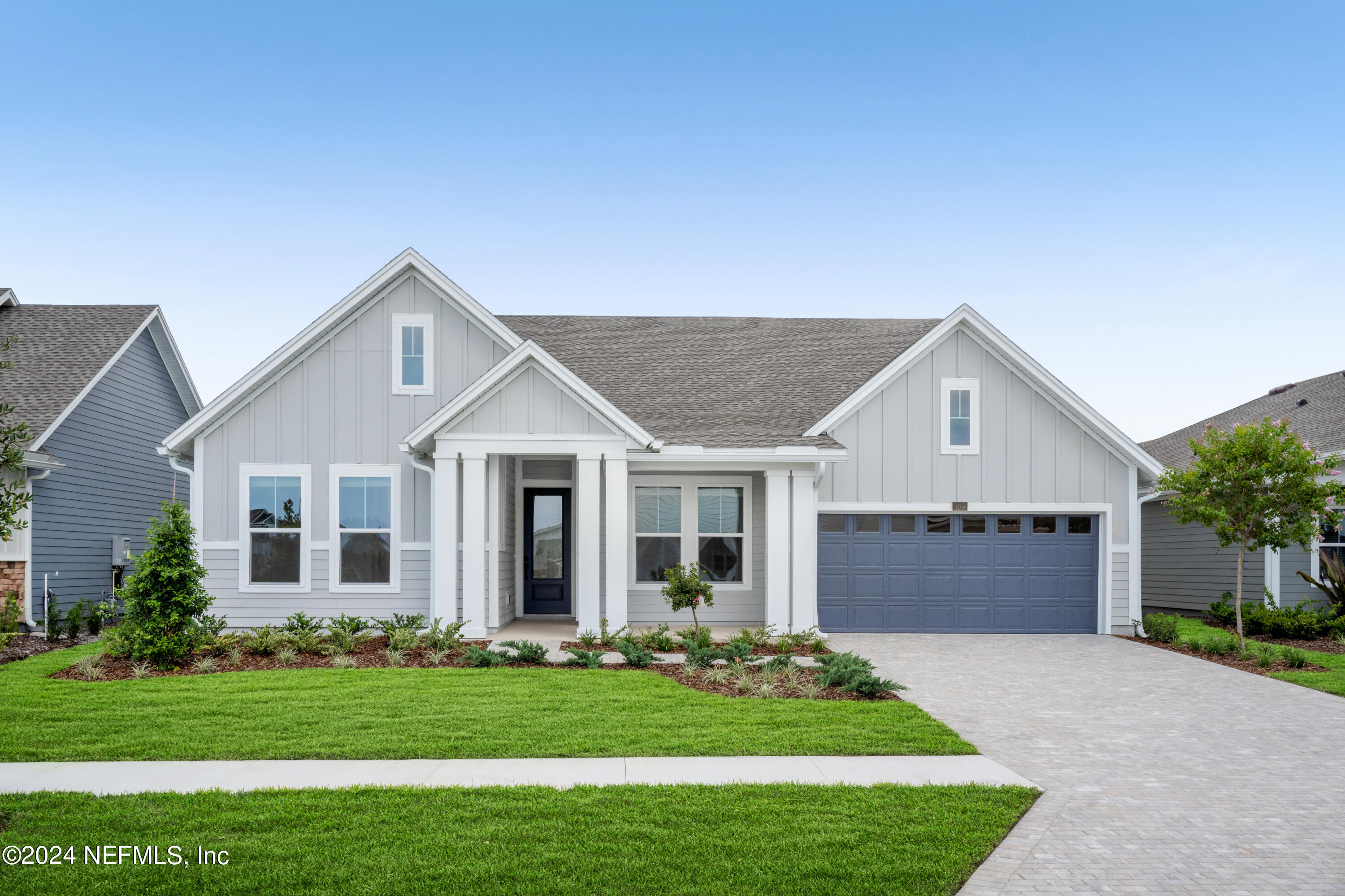 a front view of house with a garden and yard