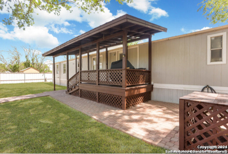 a view of backyard with deck and garden