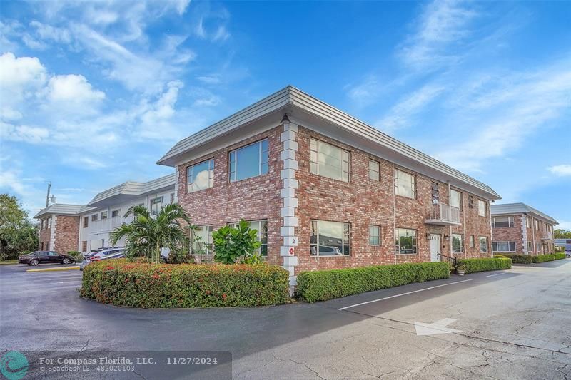 a view of a brick building next to a yard