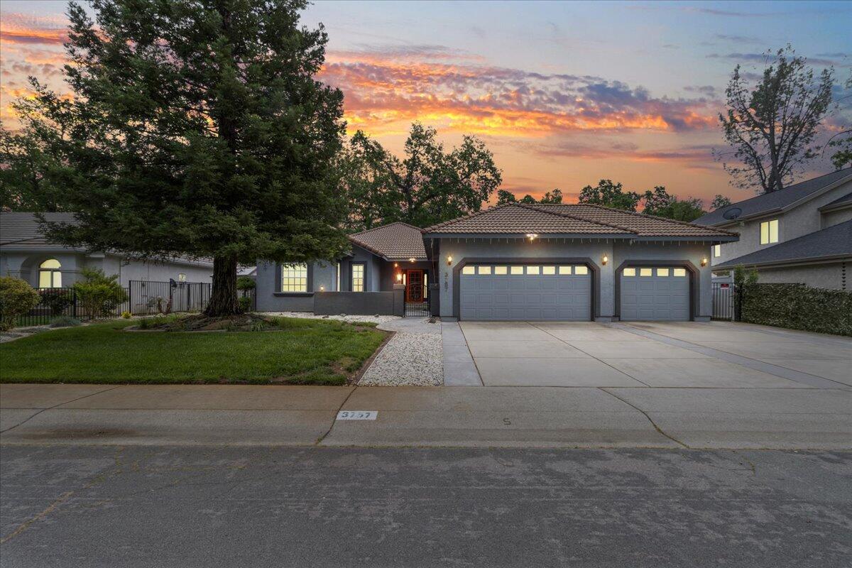 a front view of a house with a yard and garage