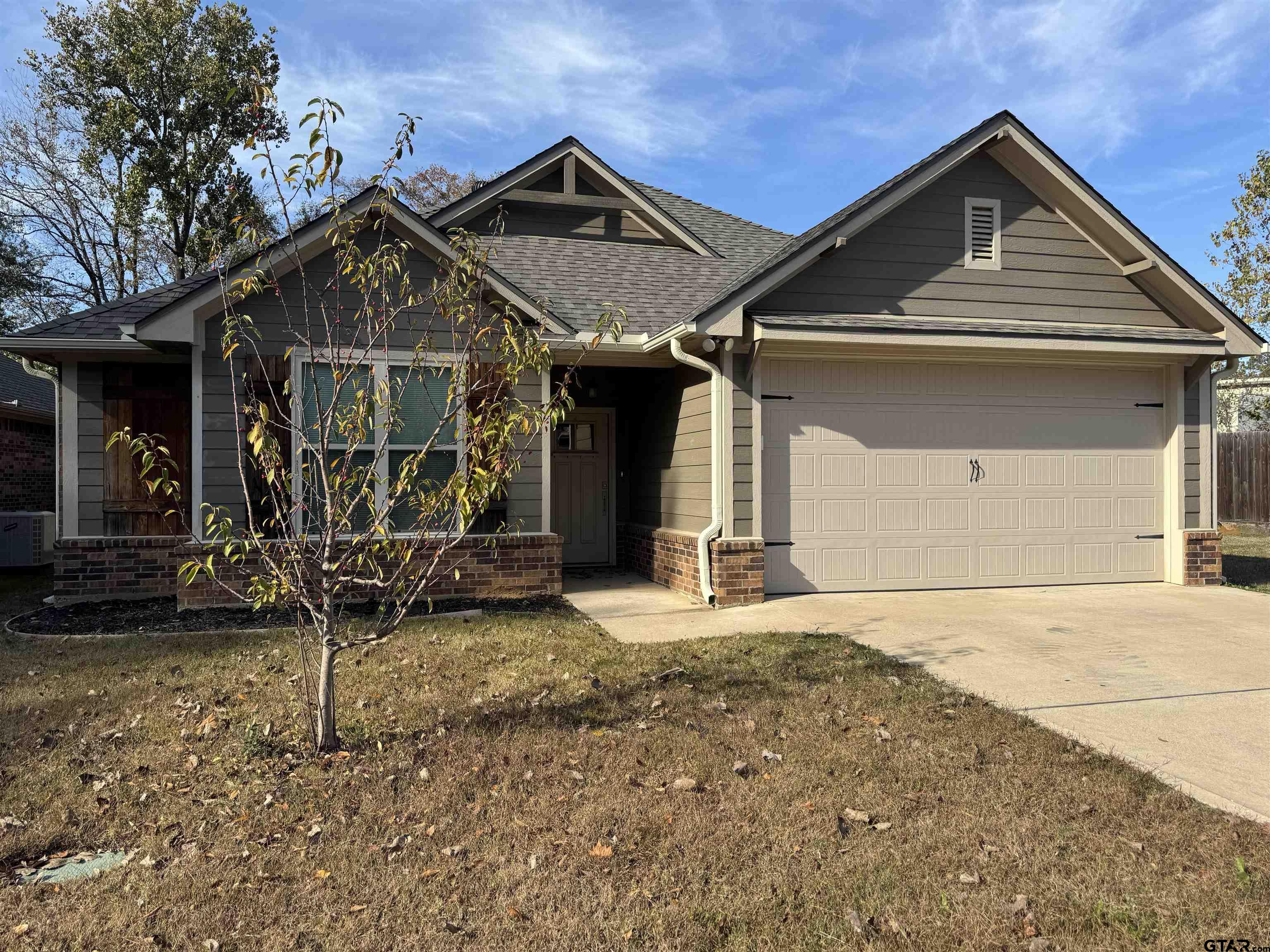 a front view of a house with parking area