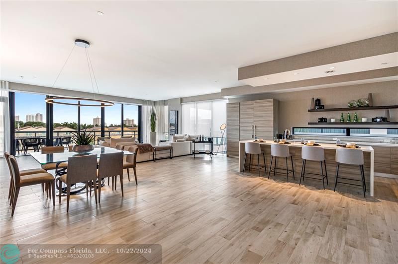 a dinning room and kitchen view with a large window appliances