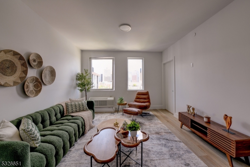 a living room with furniture a rug and a window