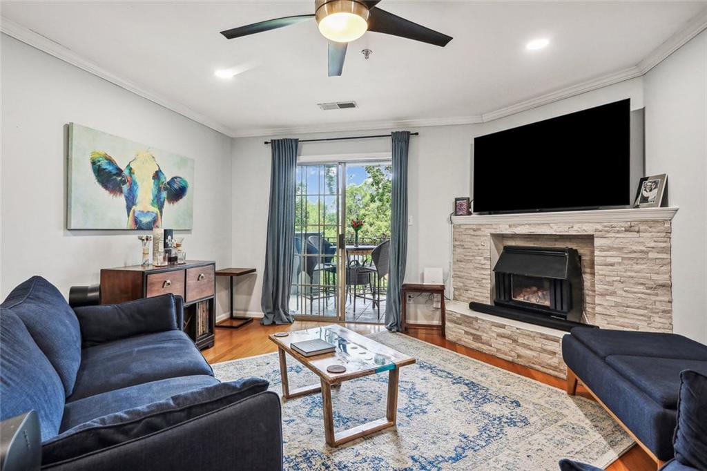 a living room with furniture a flat screen tv and a fireplace