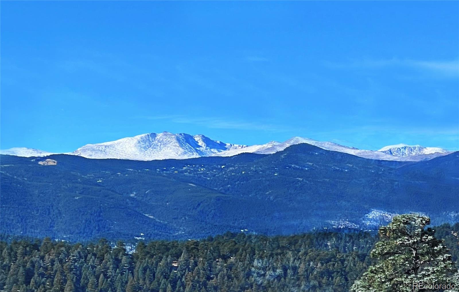 a view of a big yard with mountain view