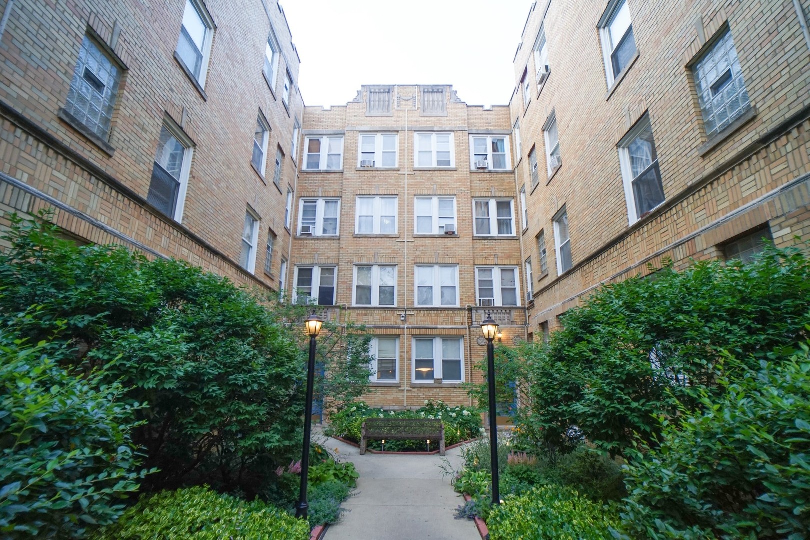 a view of a brick building next to a big yard