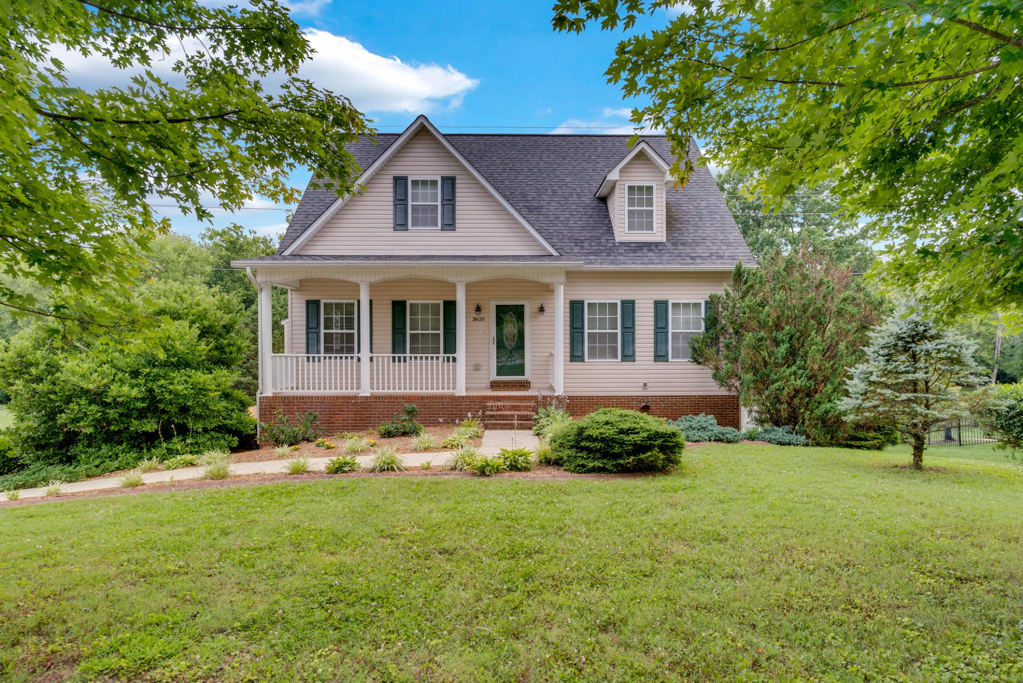 a front view of a house with a yard