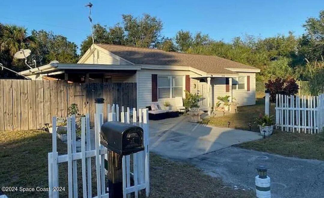 a front view of house with yard outdoor seating and barbeque oven