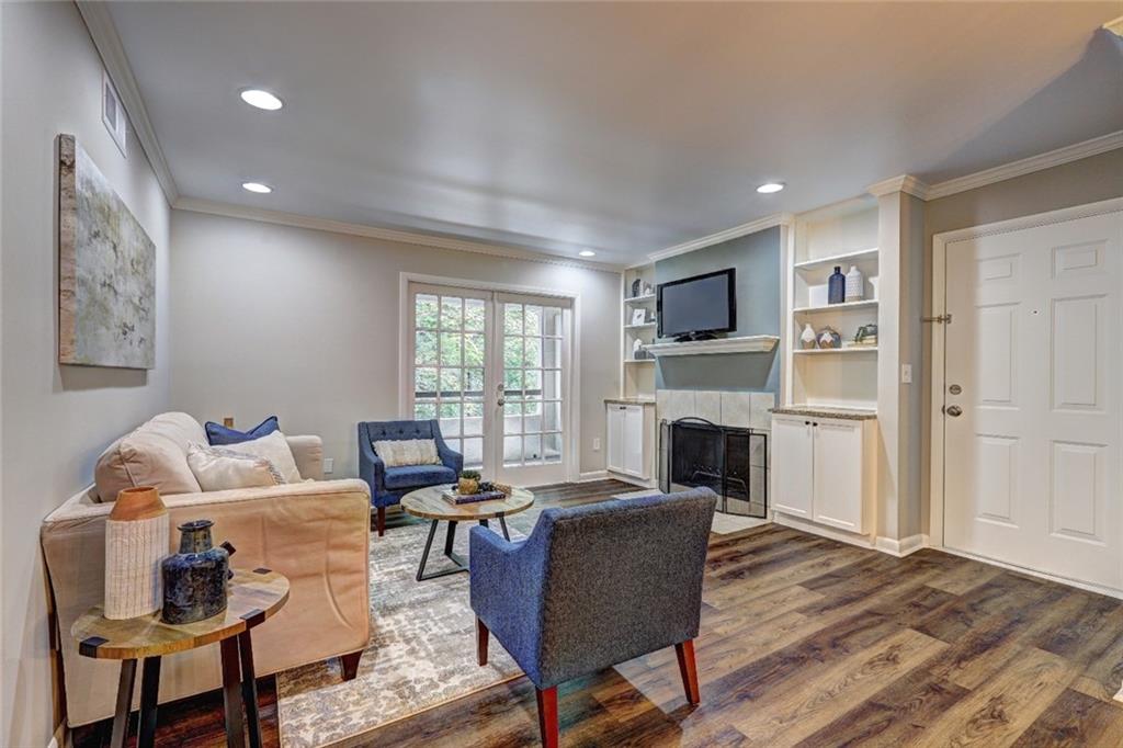 a living room with furniture a fireplace and a flat screen tv