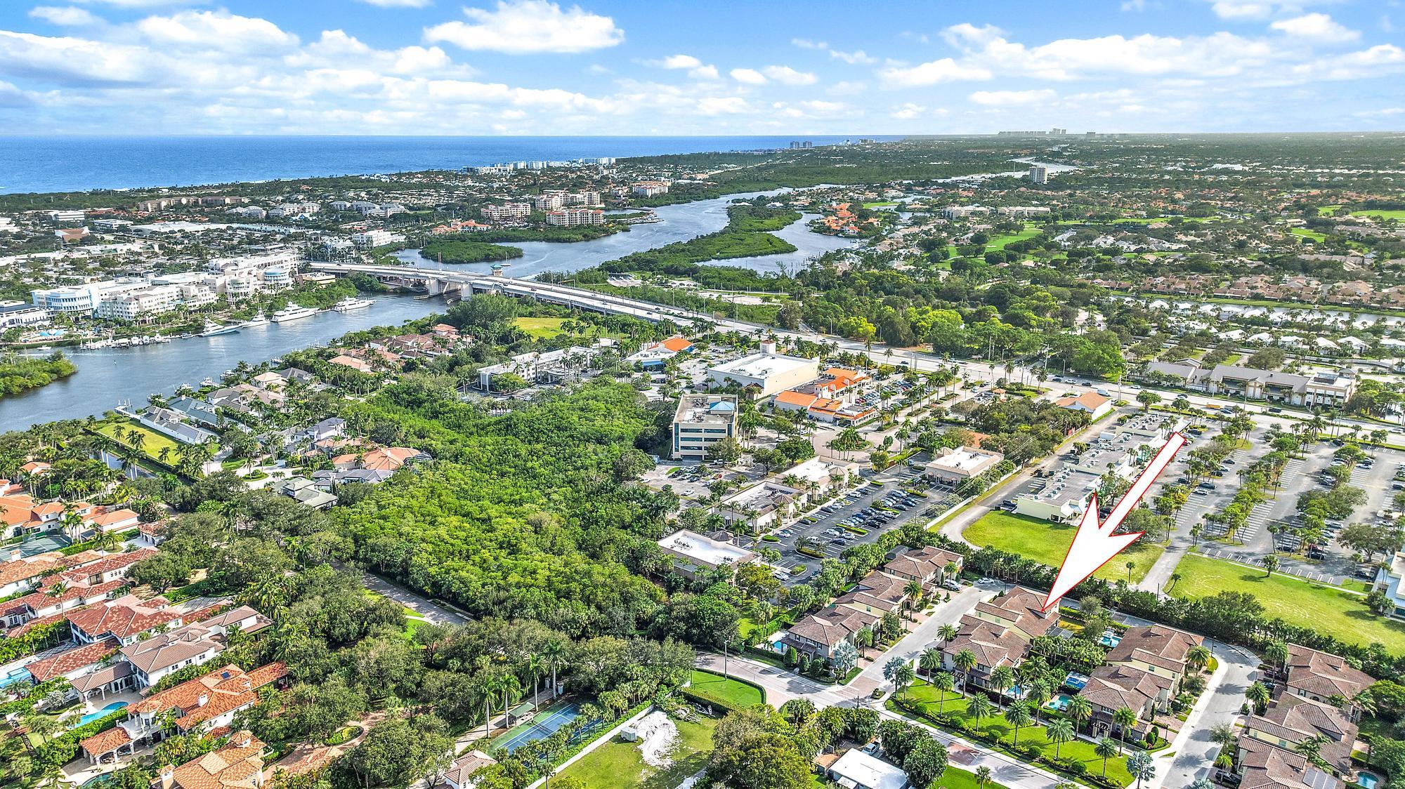 an aerial view of residential houses with outdoor space and trees