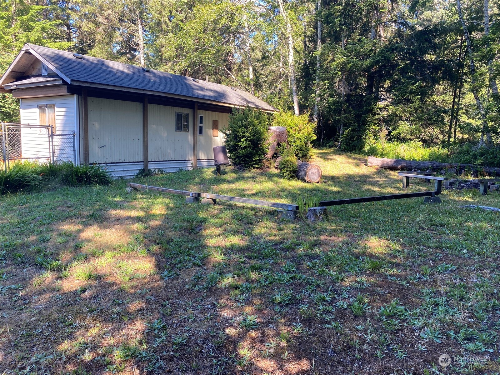 a view of backyard of house with green space