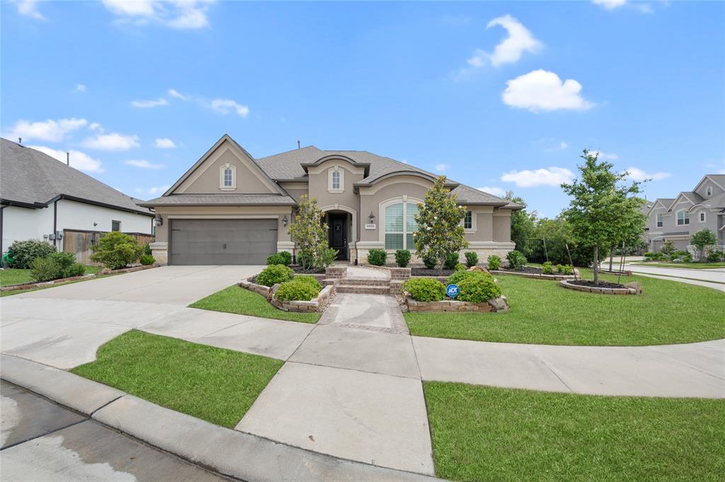 a front view of a house with a garden and yard