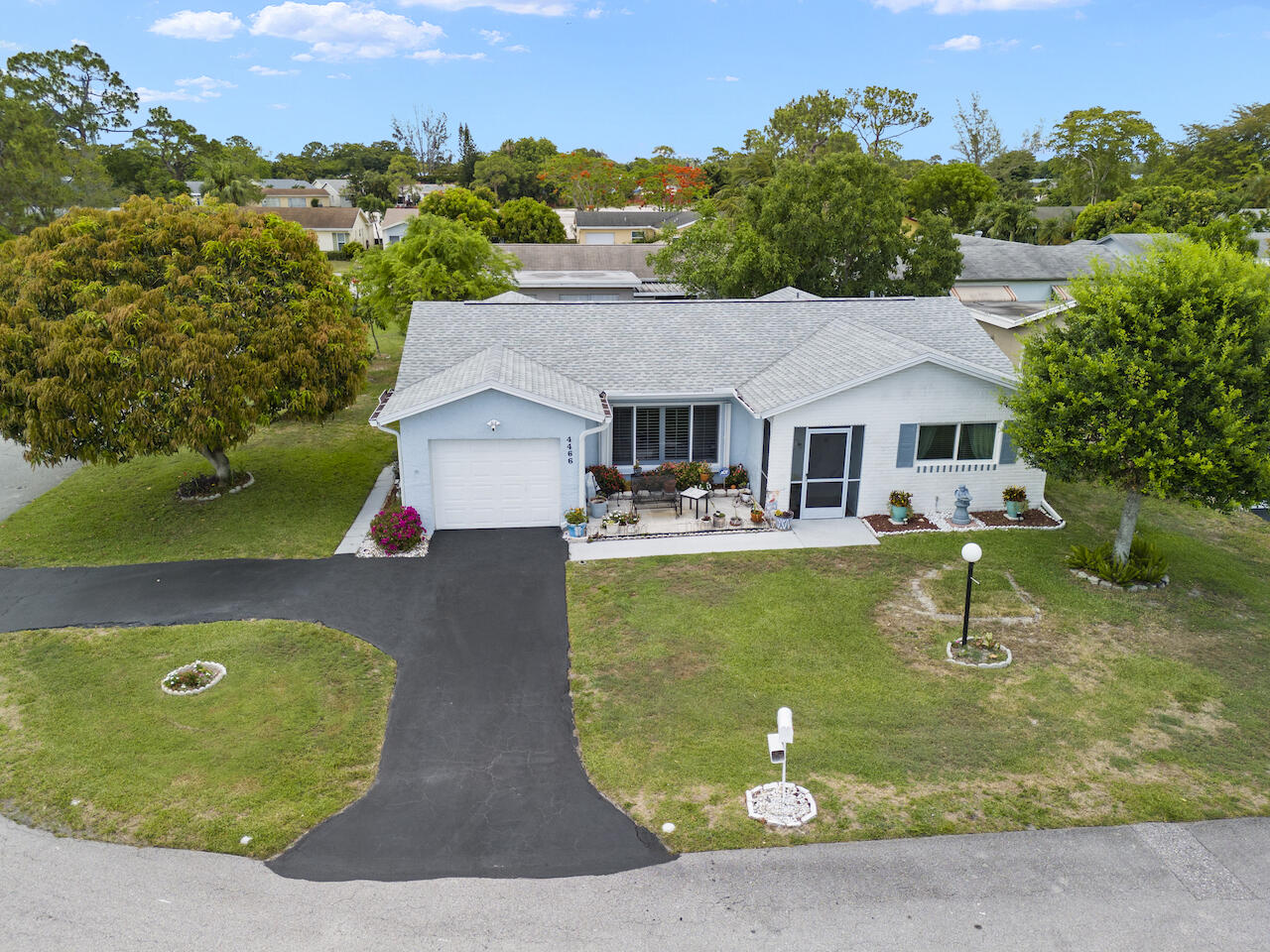 an aerial view of a house with swimming pool and a yard