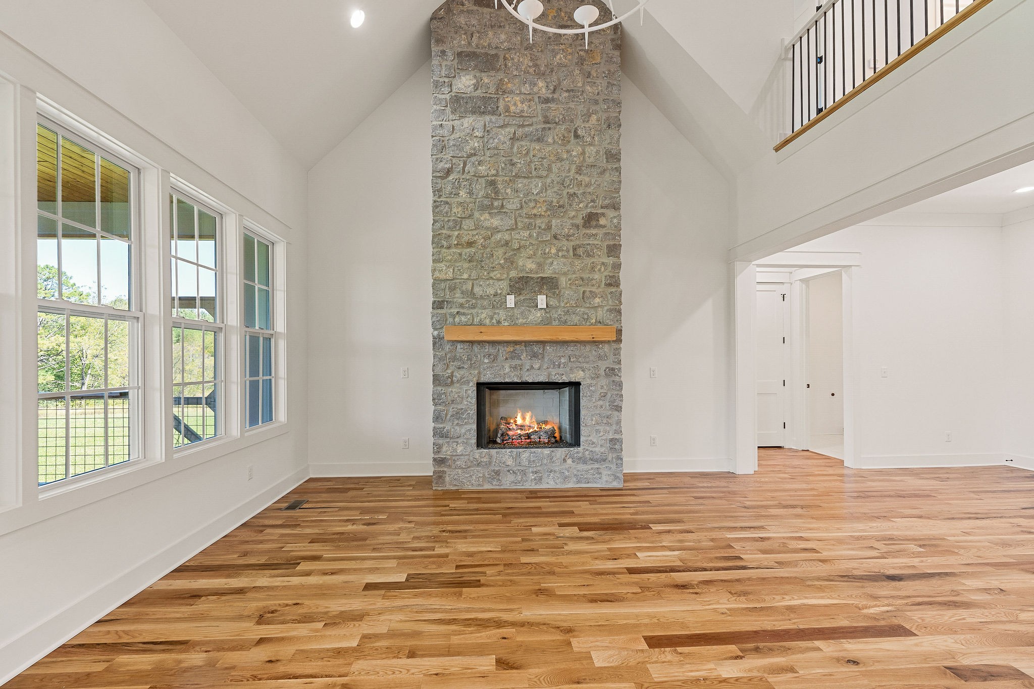 a view of an empty room with window and fire place