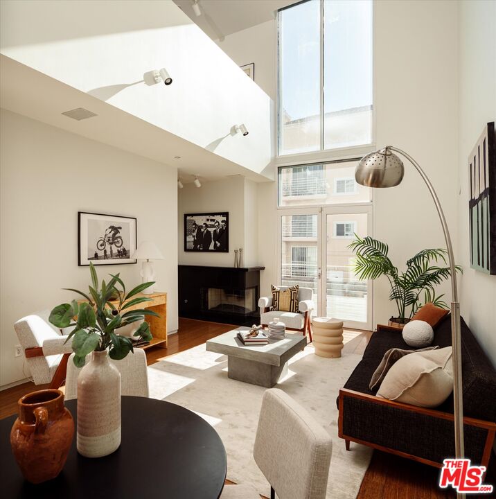 a living room with furniture flowerpot and a potted plant